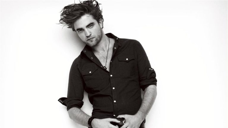 Black-and-white portrait of Robert Pattinson in a dark shirt.
