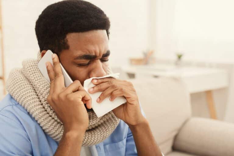 Sick black man calling on phone. to doctor