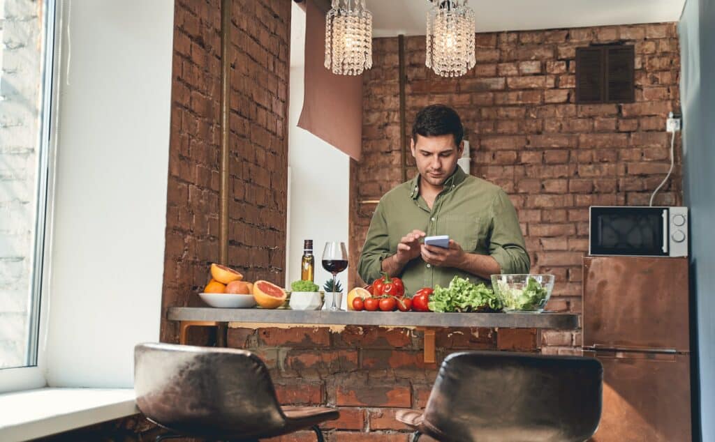 Man with a phone searching for a recipe