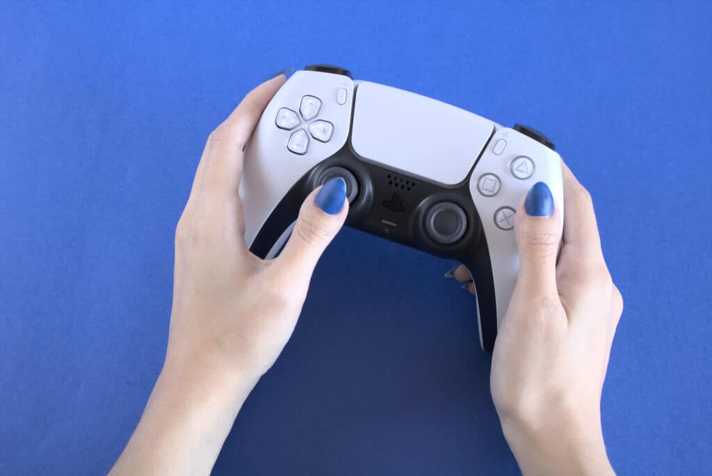 Girl holding Sony gamepad