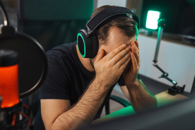 Angry young gamer playing game on computer