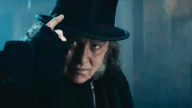 Johnny Depp as Ebenezer Scrooge tipping his top hat