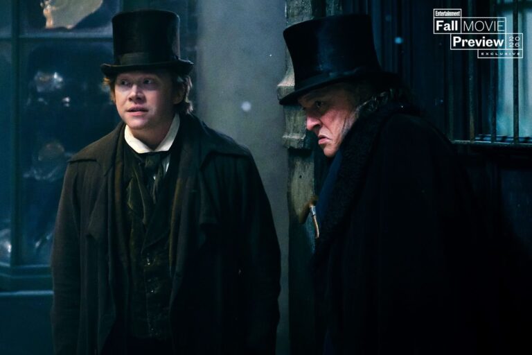 Johnny Depp as Ebenezer Scrooge beside Rupert Grint as Bob Cratchit
