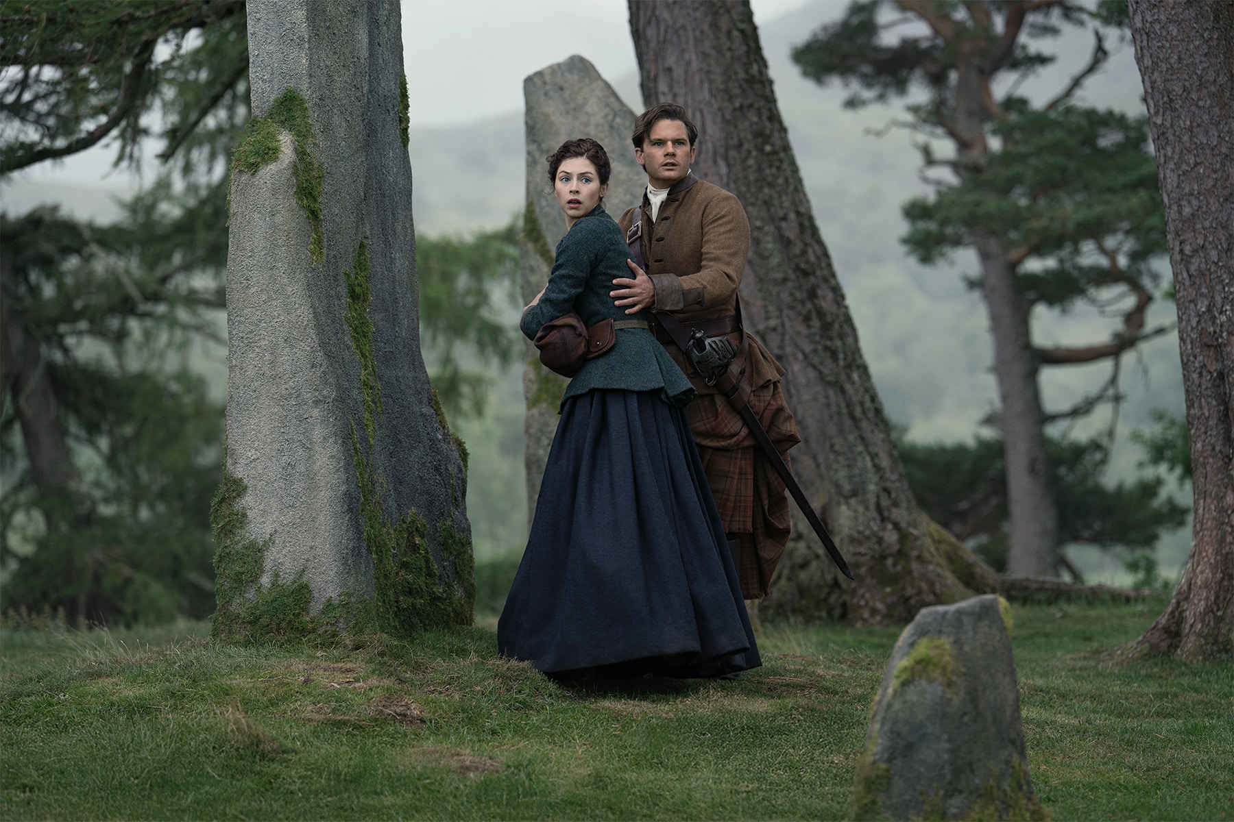Julia and Henry Beauchamp stand together by the standing stones