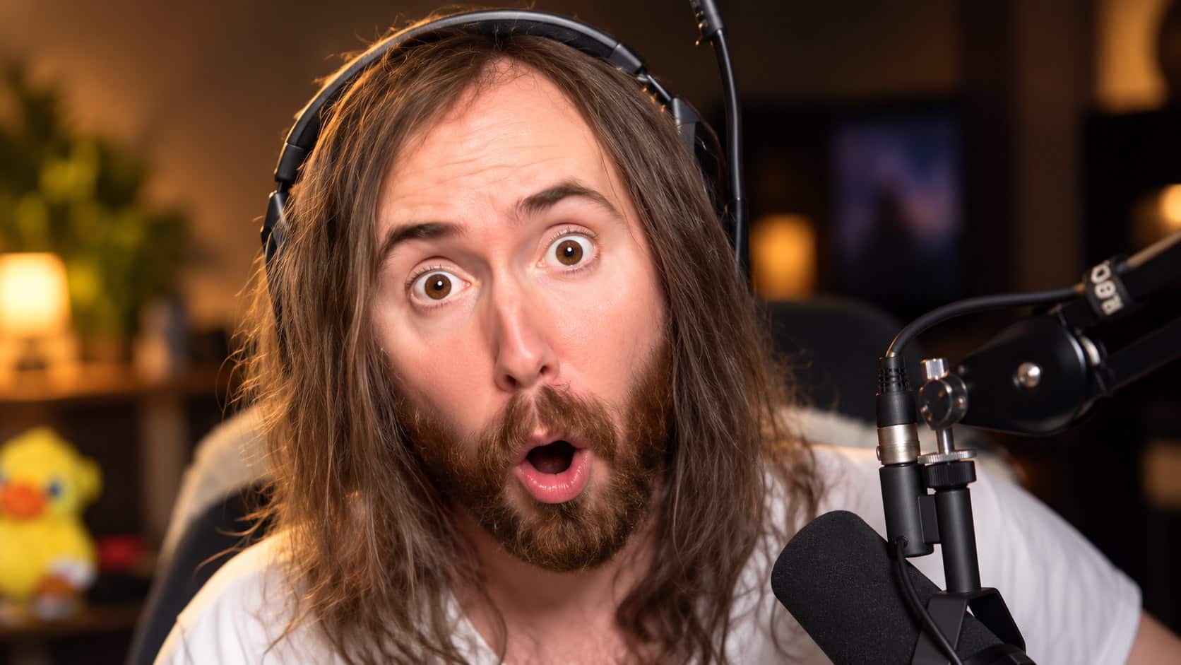 Illustrative portrait of Asmongold wearing a headset at a microphone