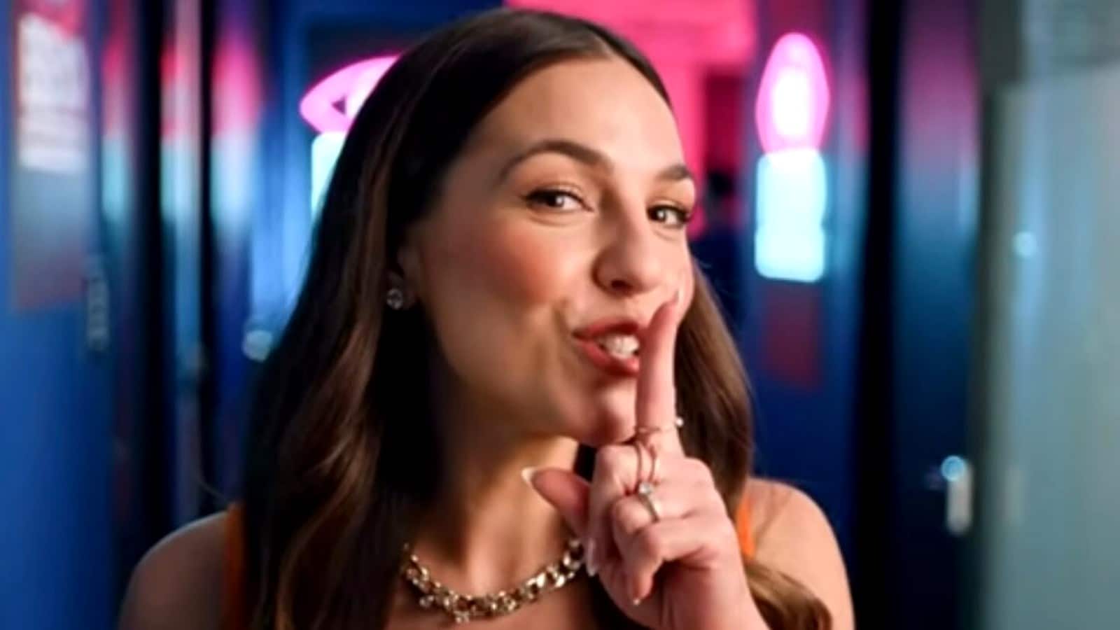 Big Brother Australia host Mel Tracina gestures for viewers to keep quiet