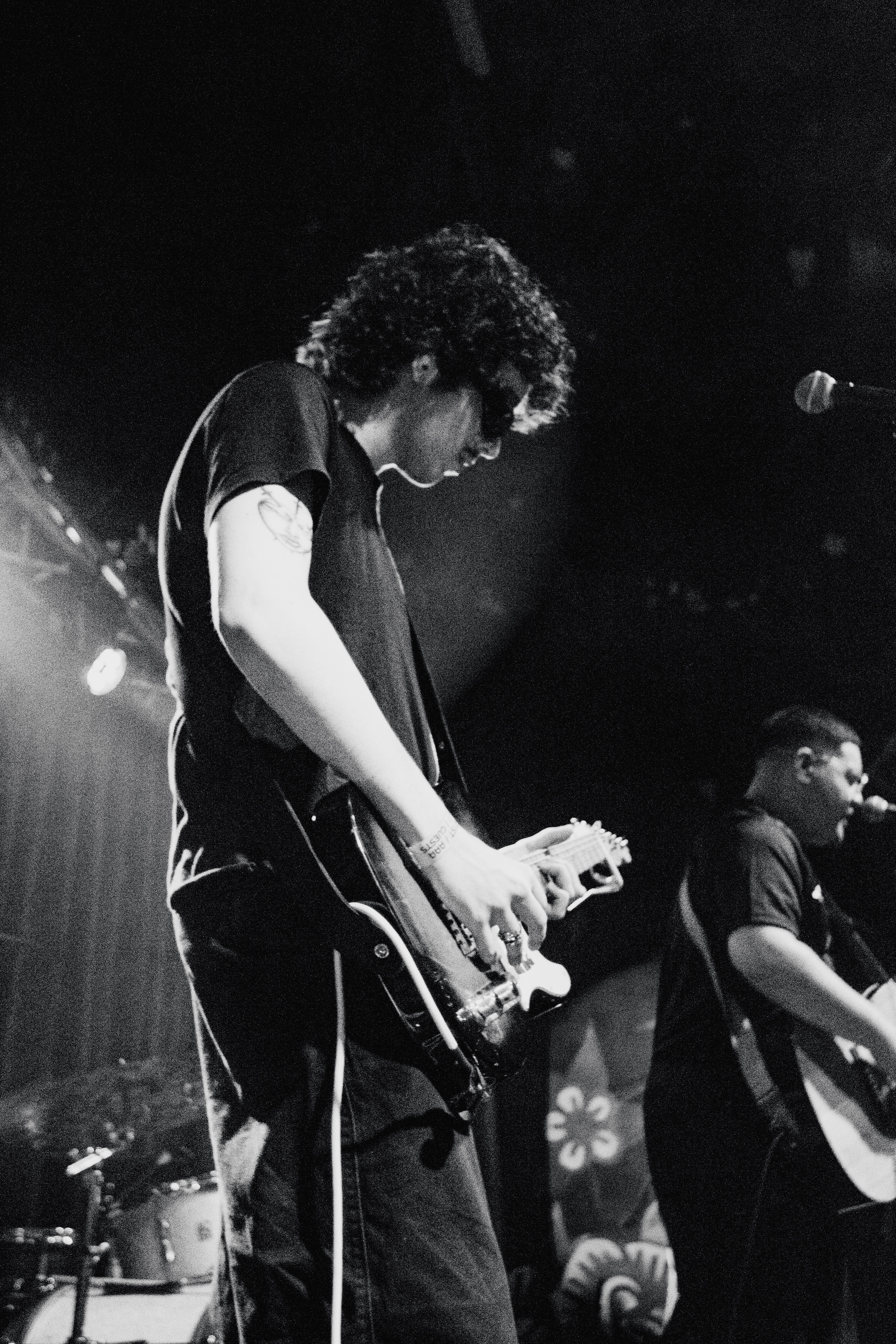 Dallow guitarist performing in a black-and-white live photograph