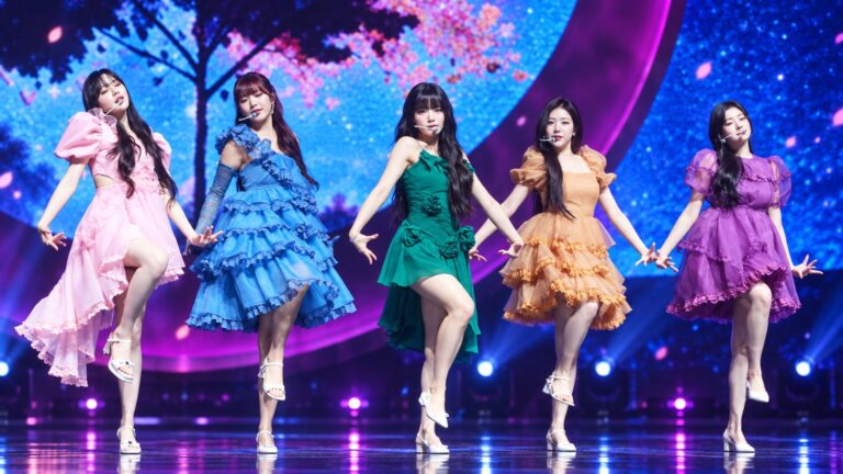 FIFTY FIFTY performing on a colourful concert stage