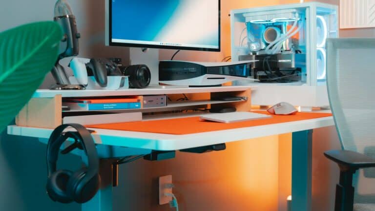 Gaming room desk with a monitor, PlayStation 5, gaming PC, controllers and microphone