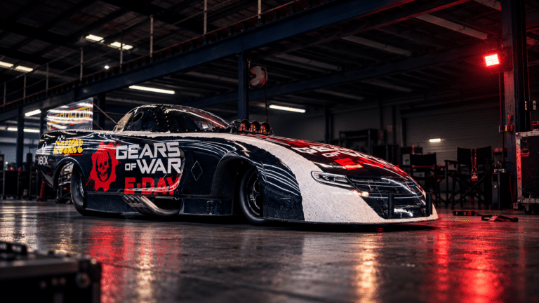 Official Gears of War E-Day drag car photographed alone in a darkened pit garage