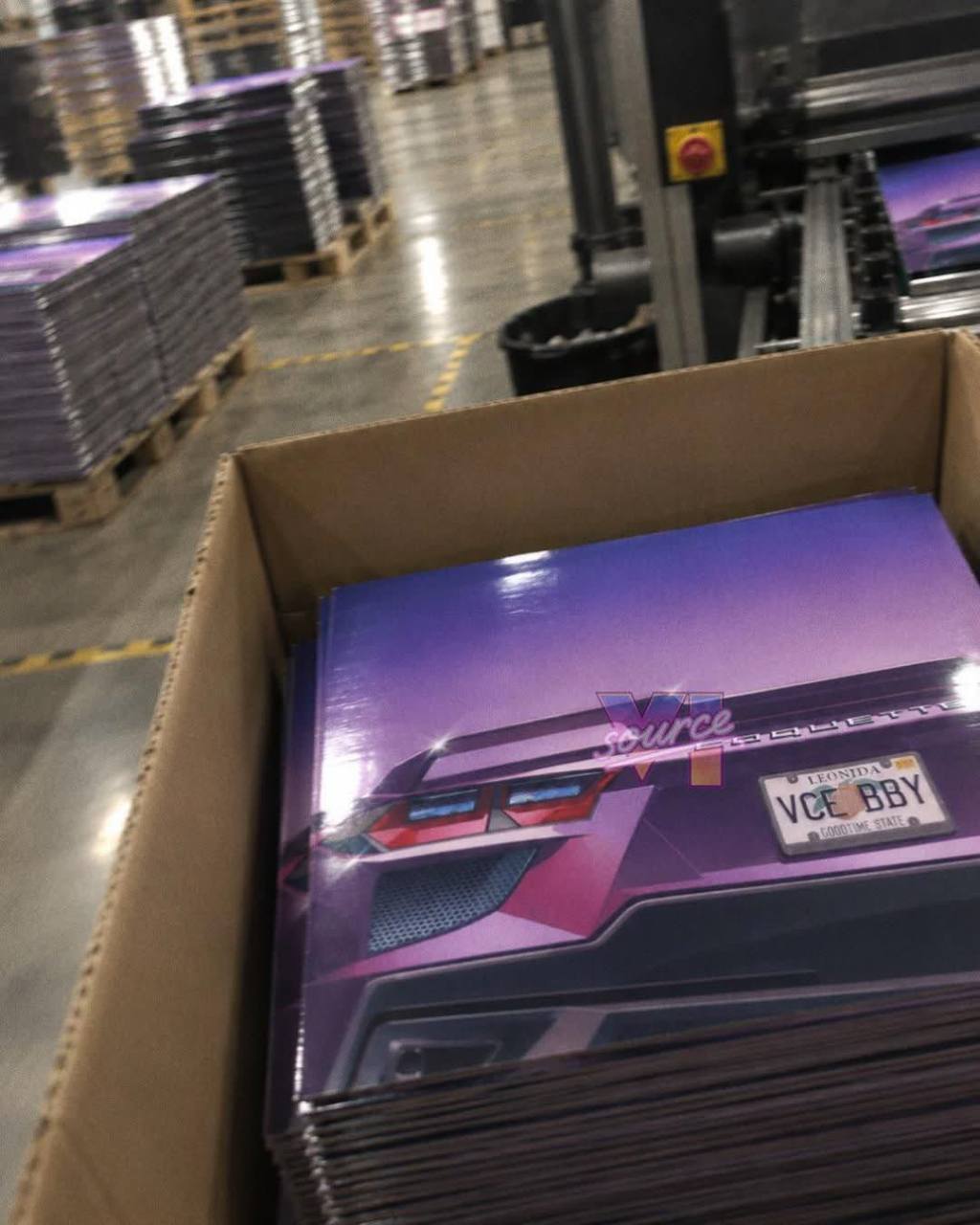 Stacks of apparent GTA VI vinyl sleeves inside a printing factory