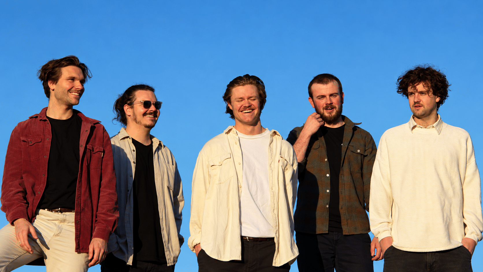BOCCE's five members outdoors beneath a blue sky in an enhanced publicity photograph