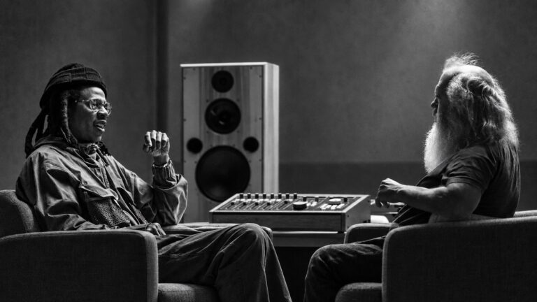 Jay-Z and Rick Rubin sit opposite each other in a recording studio