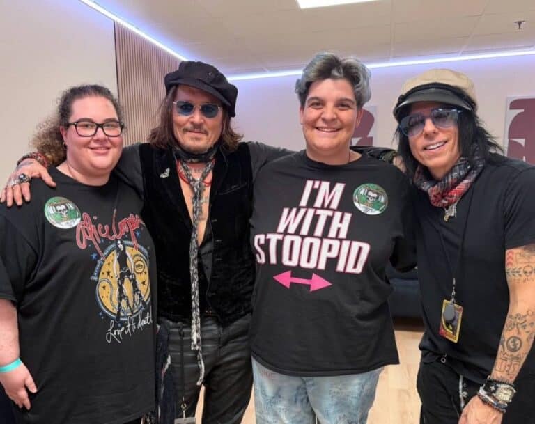 Johnny Depp, second from left, smiling in a four-person group photograph in Budapest