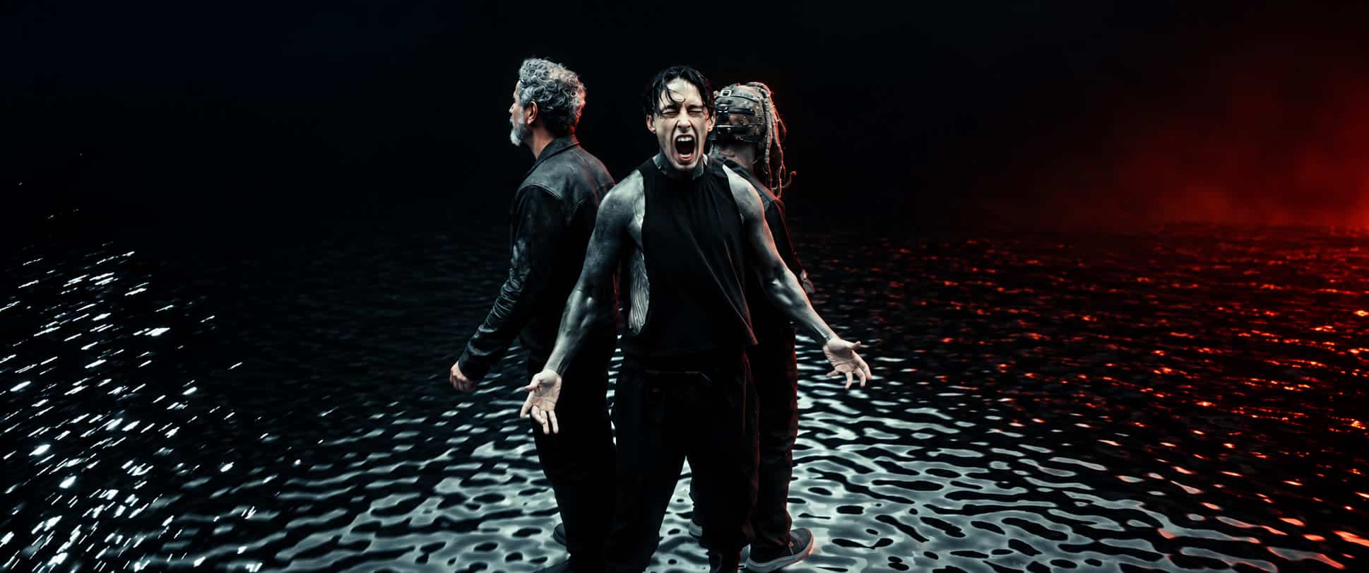 Ronnie Radke with Serj Tankian and Corey Taylor in the Joseph music video, against a dark reflective backdrop
