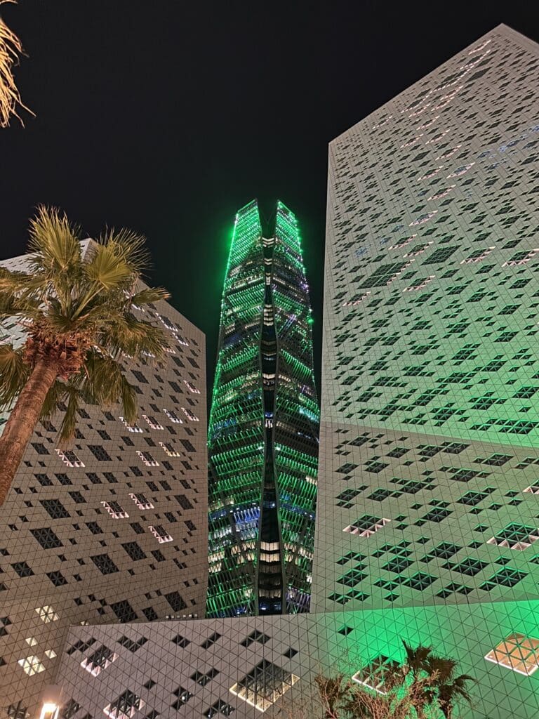 The Public Investment Fund Tower illuminated at night in Riyadh.