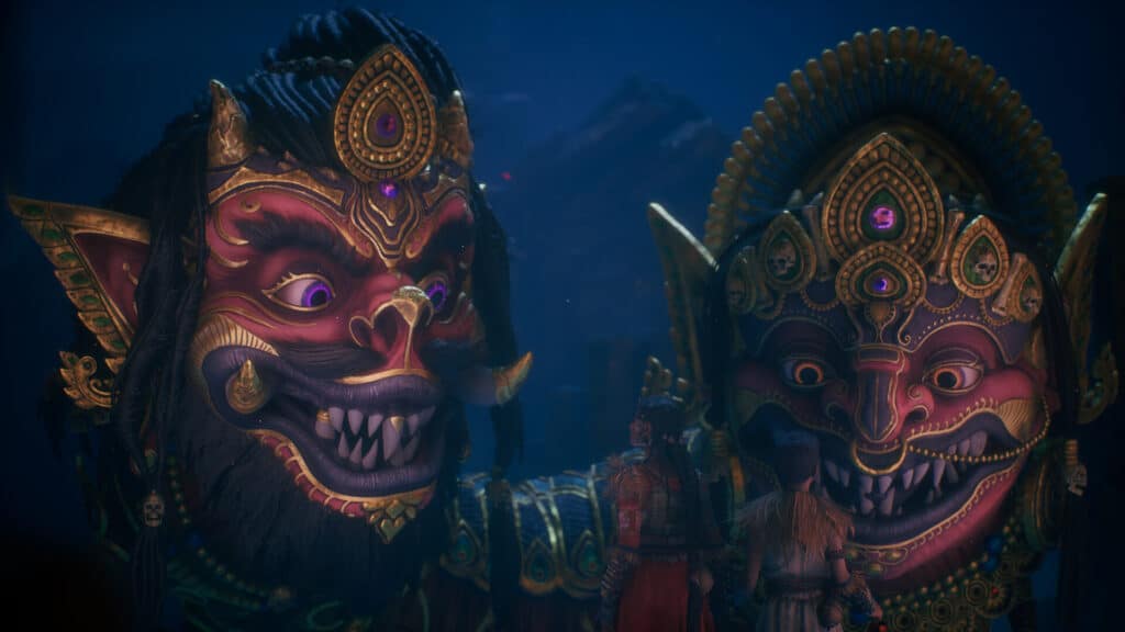Raji and Darsh stand before enormous mythic masks in Raji Kaliyuga