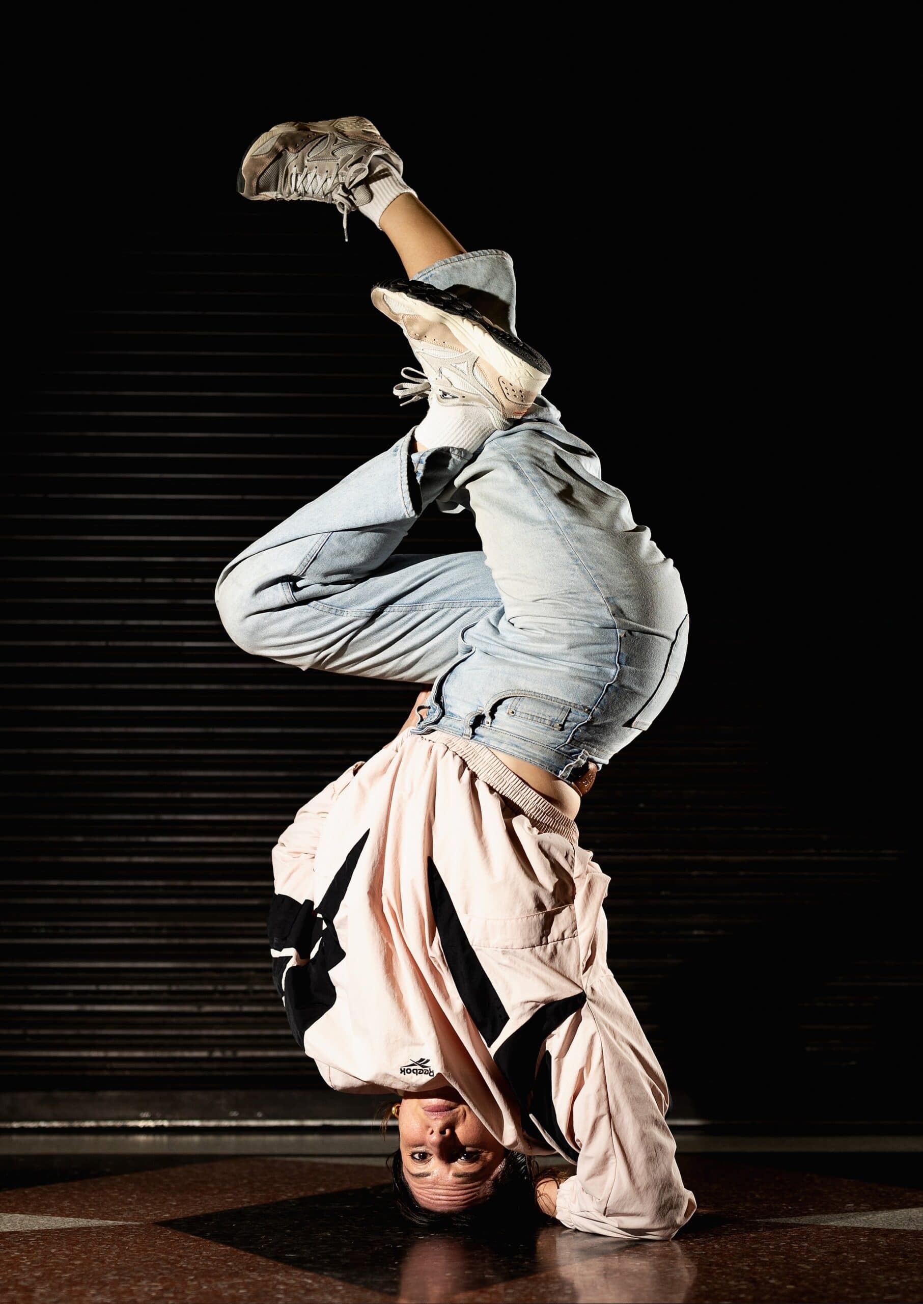 Rachael Gunn holding a headstand during a breaking performance