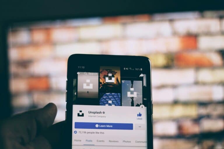 Phone in hand showing a social-media page