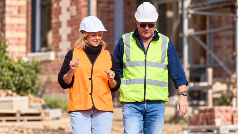 Scott Cam and Shelley Craft walking through a heritage renovation site