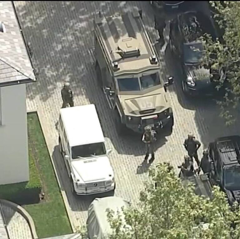 Aerial image of an armored law-enforcement vehicle and agents at a Los Angeles mansion