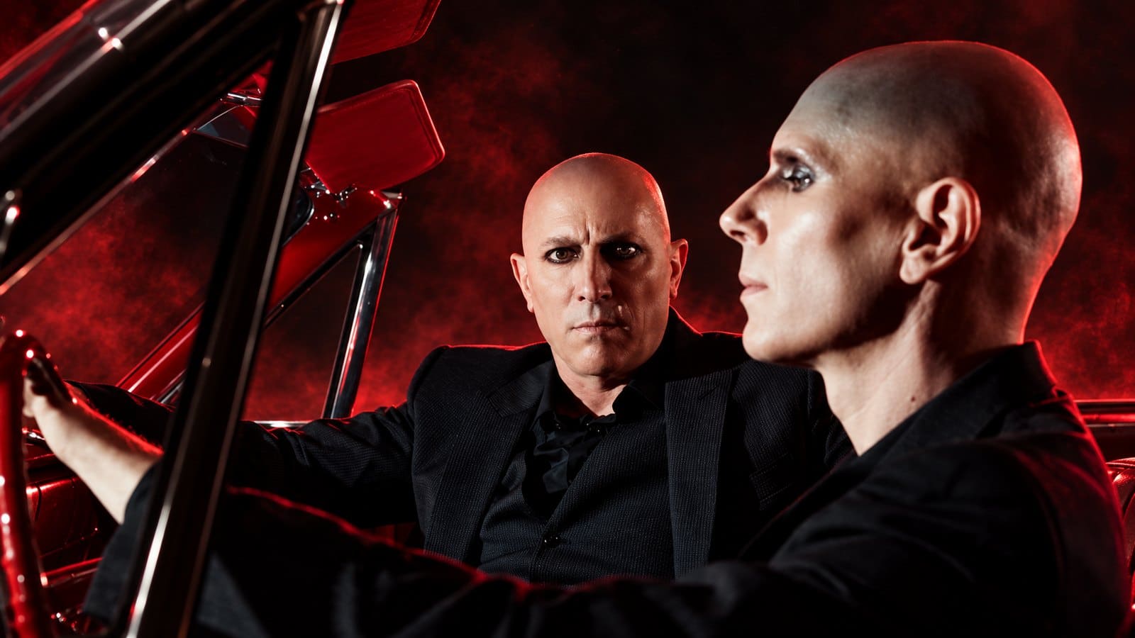 Maynard James Keenan and Billy Howerdel in a red-lit car portrait