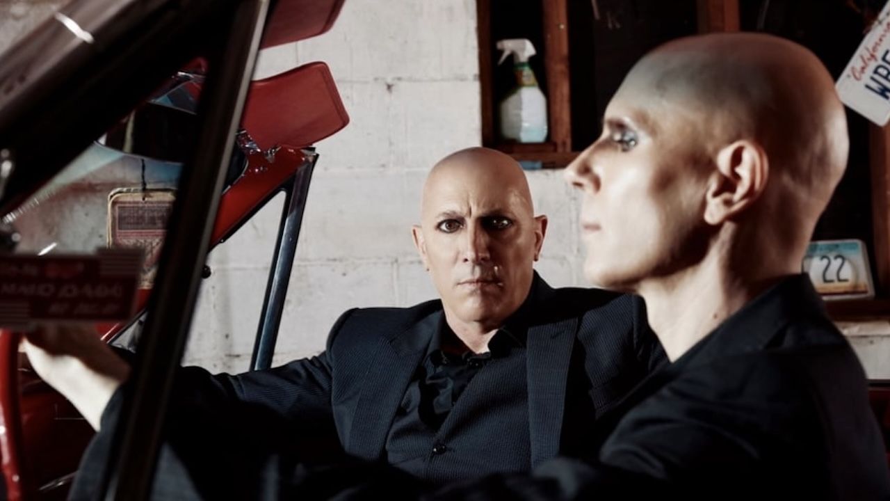 Maynard James Keenan and Billy Howerdel seated in a car