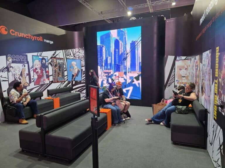 Visitors resting on couches inside the Crunchyroll Manga booth at PAX Aus 2026