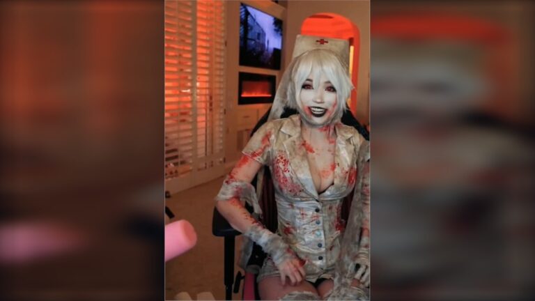 Emiru in a white wig and distressed horror nurse cosplay during her Halloween Twitch stream.