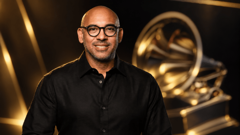 Harvey Mason Jr in front of a softly lit Grammy trophy