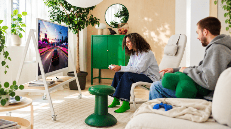 Two people gaming in a bright living room furnished with the IKEA and Xbox YXSTABY collection