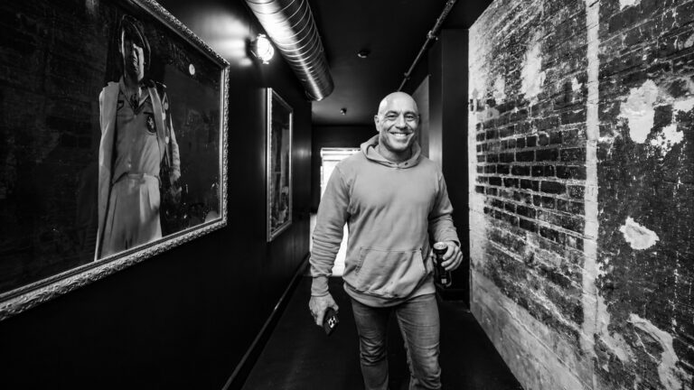 Joe Rogan in a backstage hallway in Spotify's 2026 partnership photo