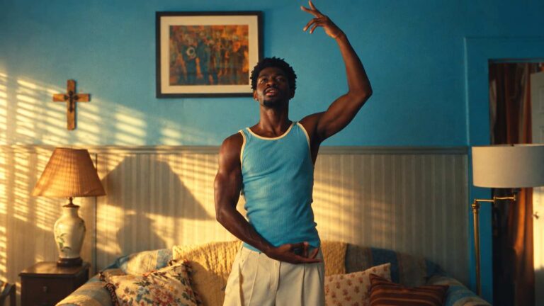 Lil Nas X dancing in a sunlit blue room in the World's Greatest music video