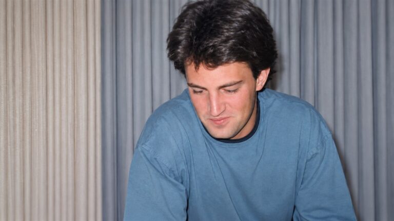 A young Matthew Perry looking down in an archival portrait