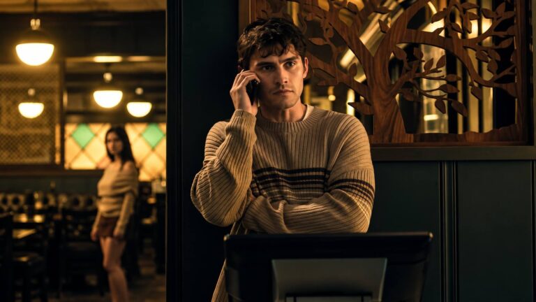 Michael Johnston on the phone while Inde Navarrette watches in the background in Obsession