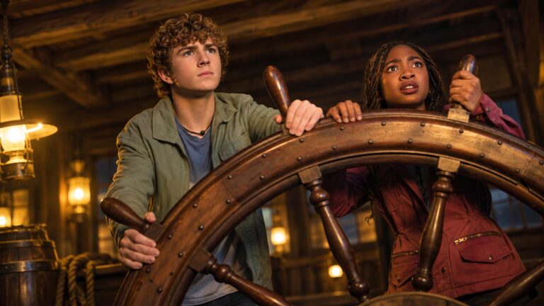 Walker Scobell as Percy Jackson and Leah Sava Jeffries as Annabeth at a ship's wheel