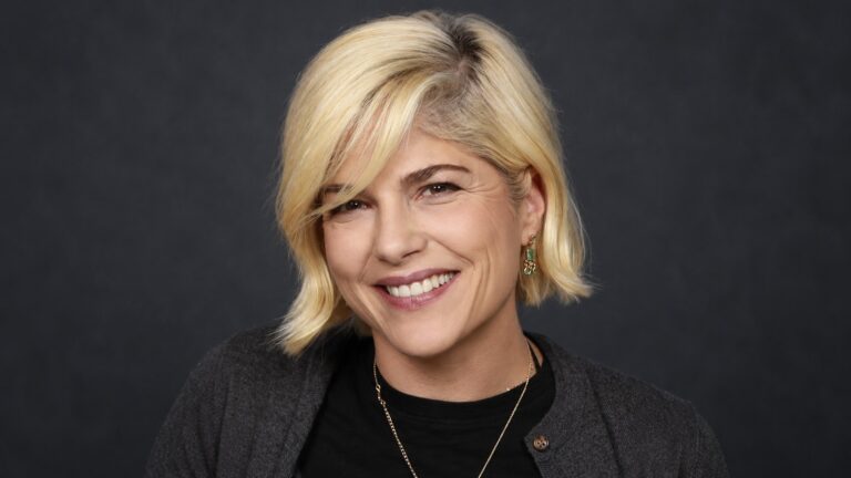 Selma Blair smiles in a polished studio portrait