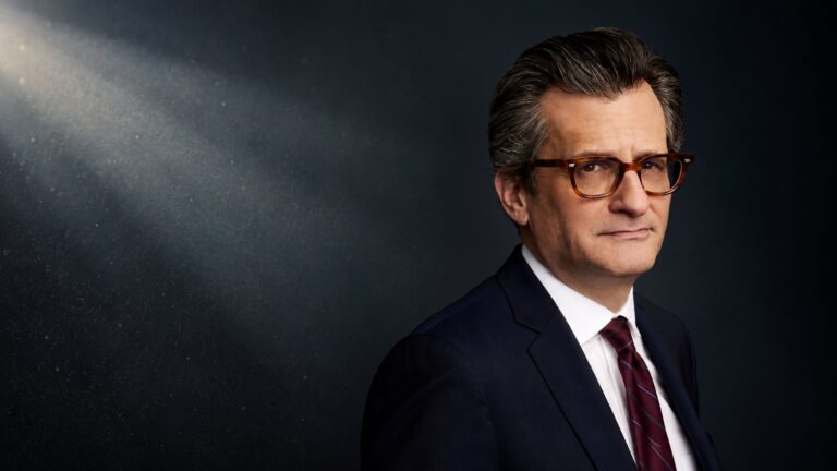 Turner Classic Movies host Ben Mankiewicz in a dark cinema setting
