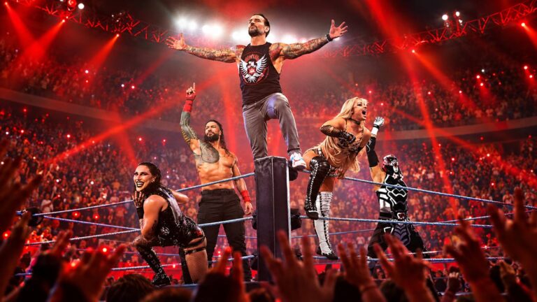 CM Punk and WWE wrestlers posing in a red-lit arena ring